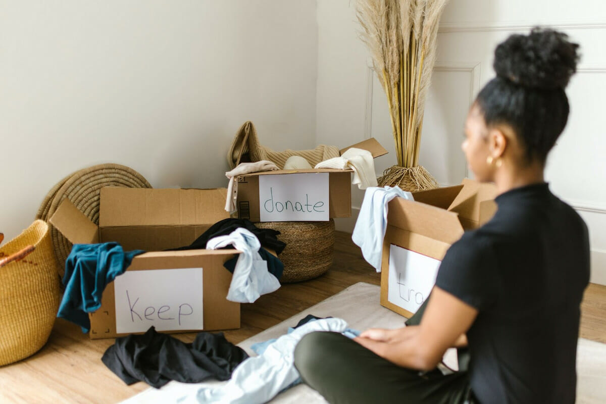 A women decluttering, sorting and donating clothing